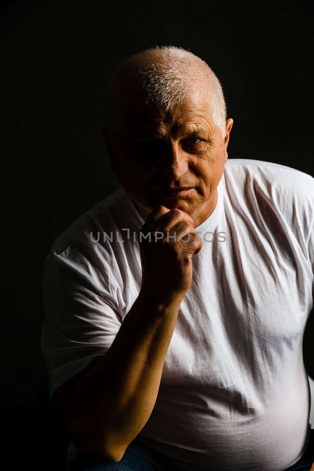 Old senior man closeup serious expression portrait by Andelov13
