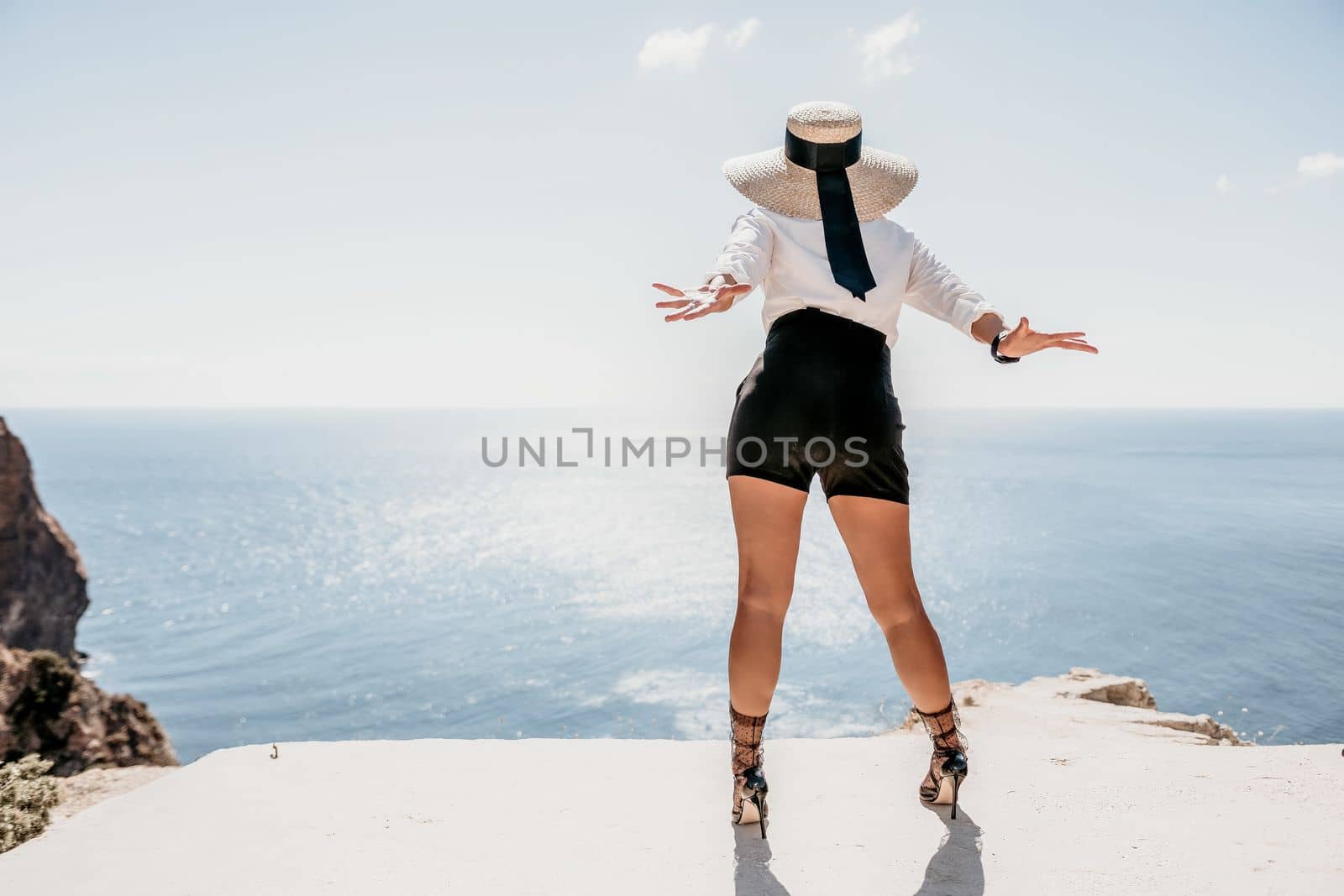 Happy girl doing yoga with laptop working at the beach. beautiful and calm business woman sitting with a laptop in a summer cafe in the lotus position meditating and relaxing. freelance girl remote work beach paradise