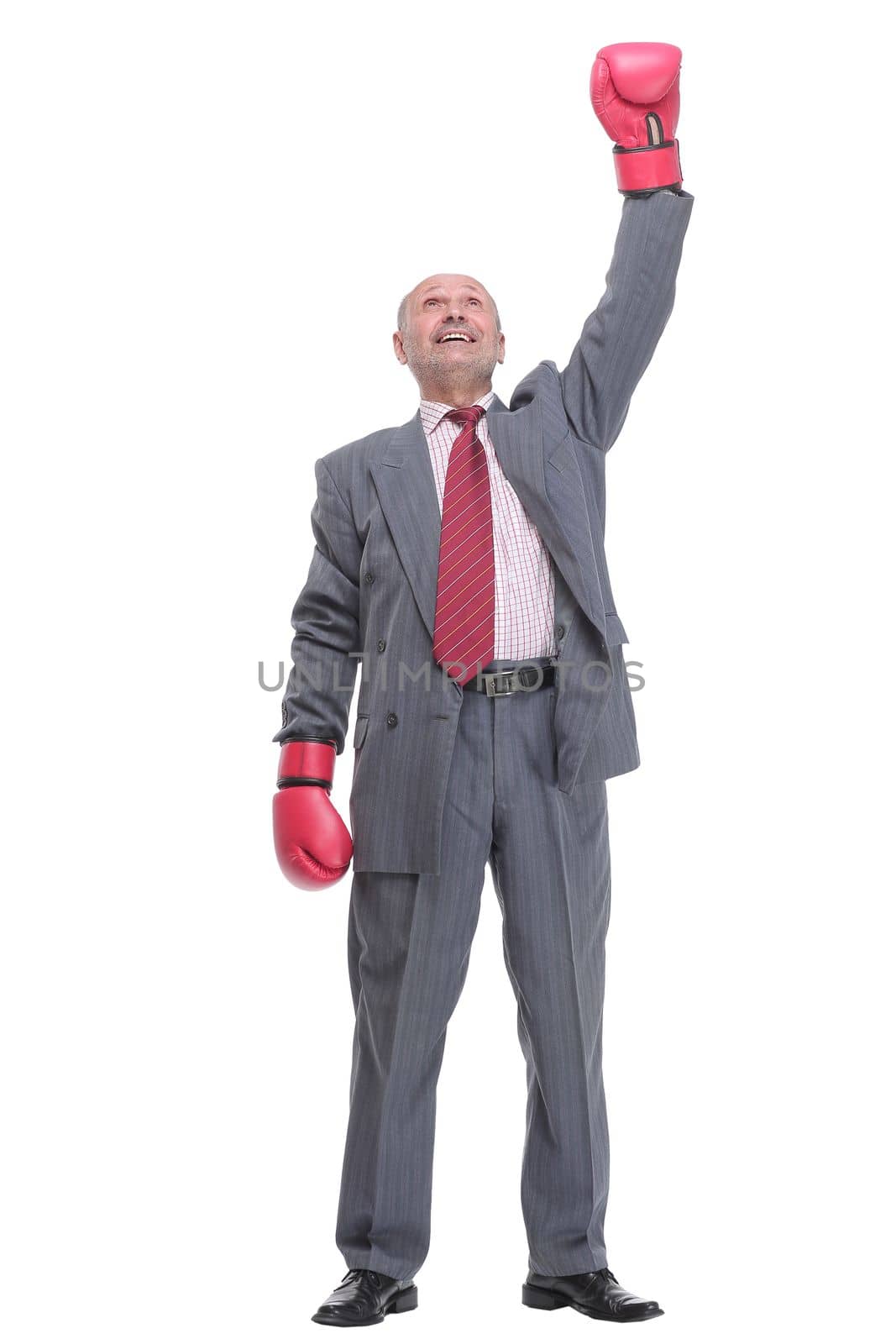 Businessman with boxing gloves on with camera focus on the man looking at camera
