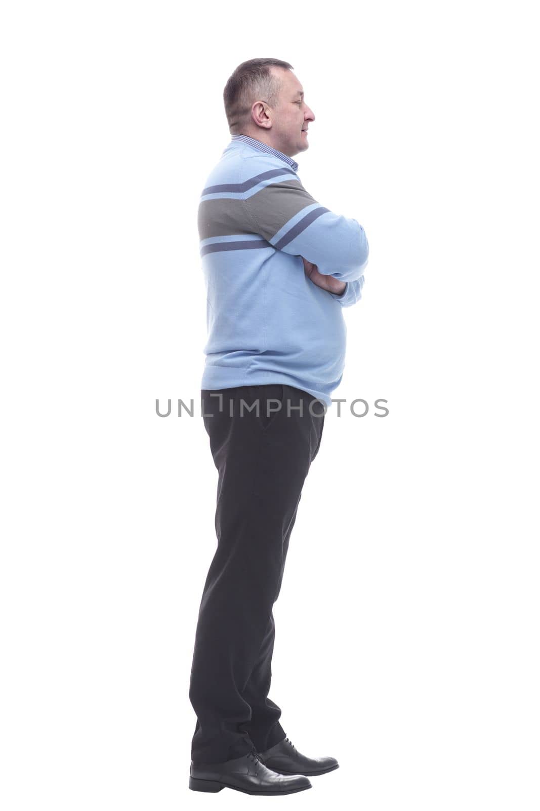 side view. smiling mature man looking at the camera . isolated on a white background