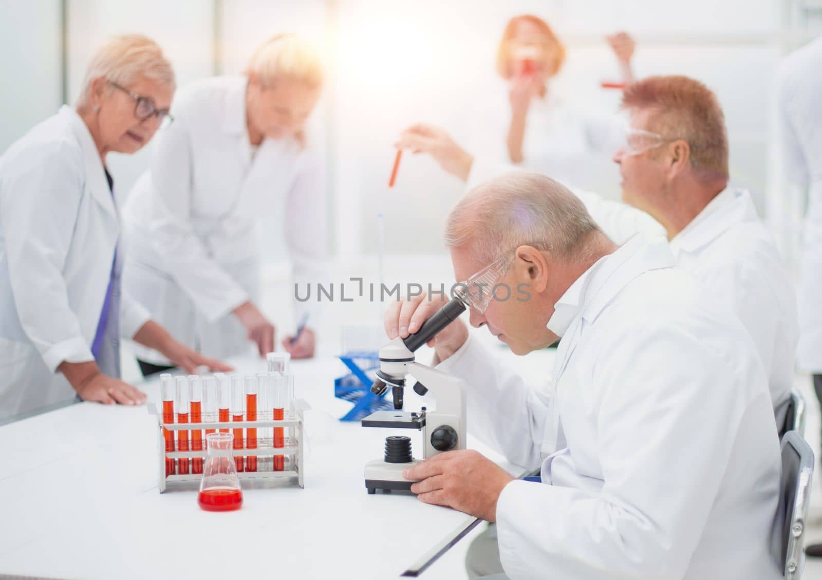 group of scientists conduct testing in the laboratory . concept of health protection.