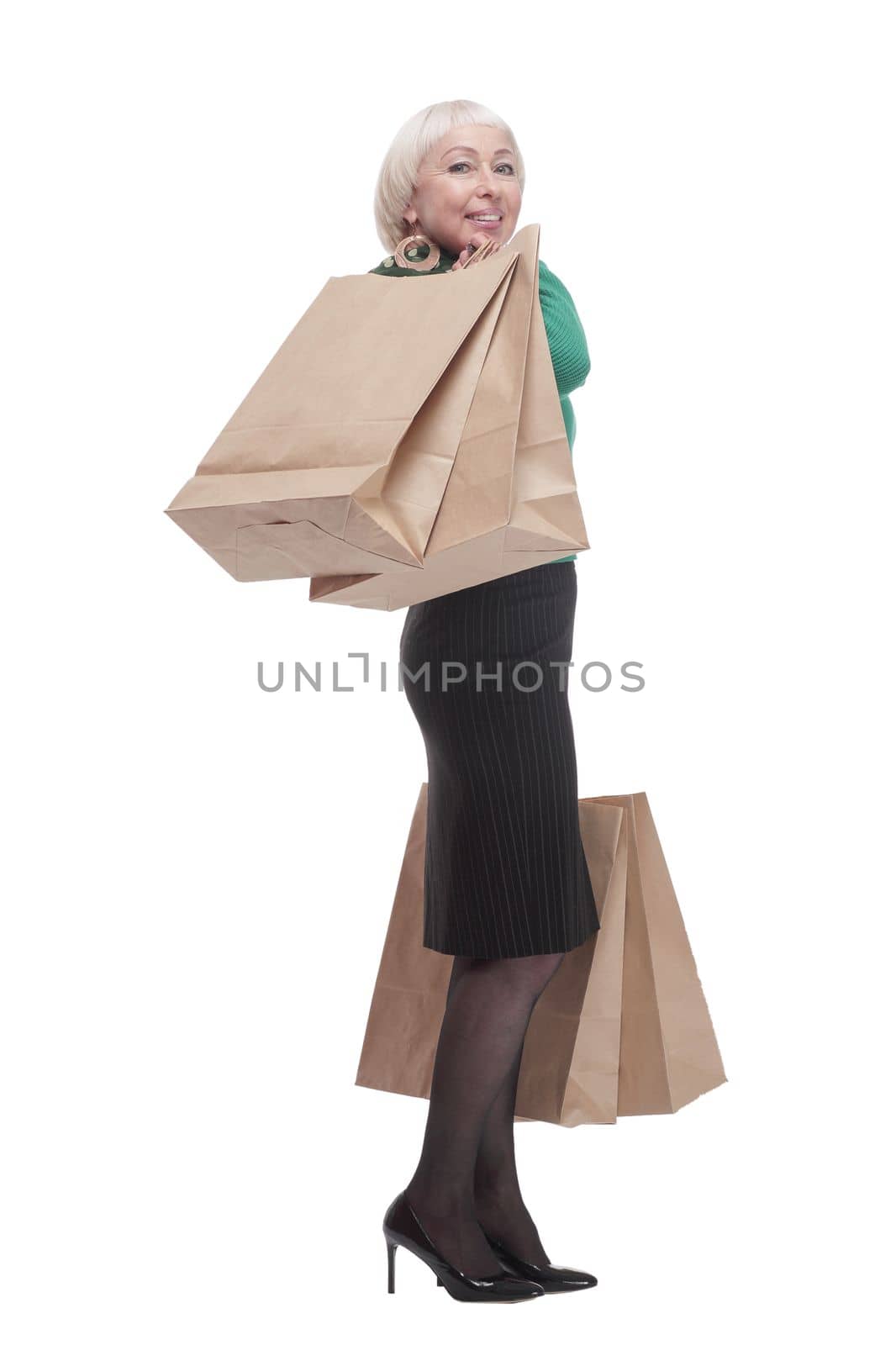 in full growth.smiling woman with shopping bags. isolated on a white background.