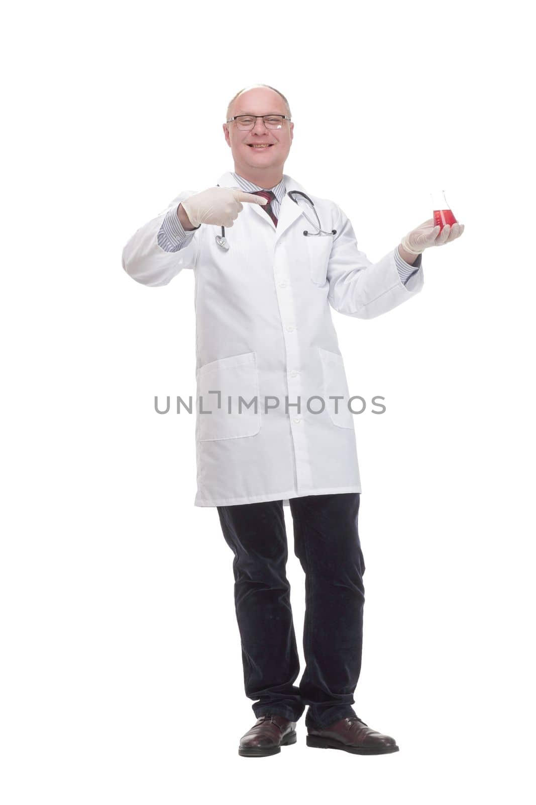 in full growth. qualified mature doctor with laboratory flask. isolated on a white background.