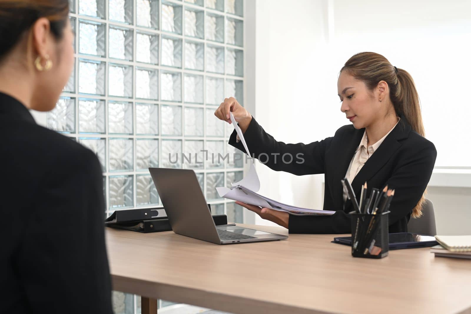 Image of female hr manager considering application female candidate during job interview. Employment and recruitment concept.