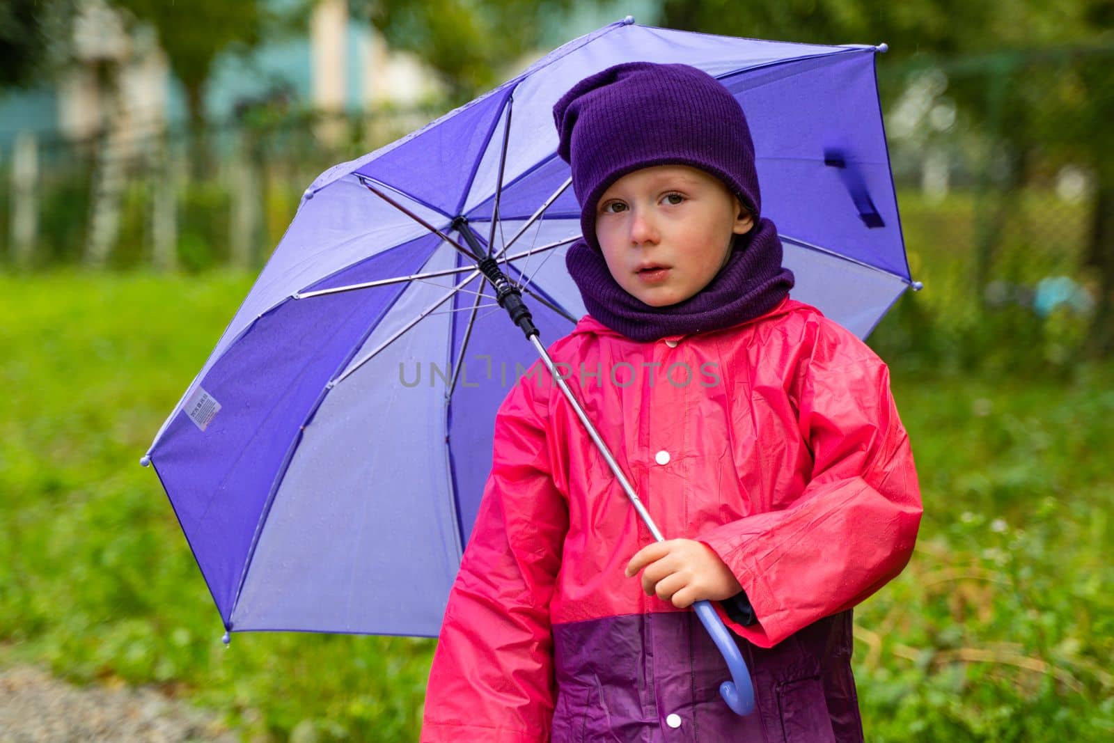 Child playing in autumn rain. Kid with umbrella. Outdoor fun for kids by any weather. Rain waterproof wear, boots and jacket for children by voffka23