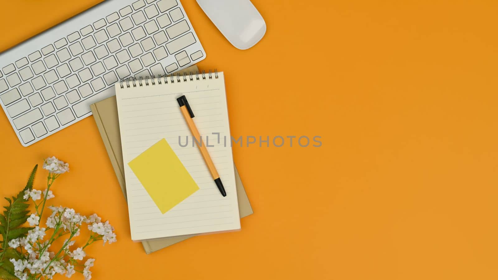 Flat lay blank notepad, pen, keyboard and mouse on yellow background. Copy space for your advertise text by prathanchorruangsak