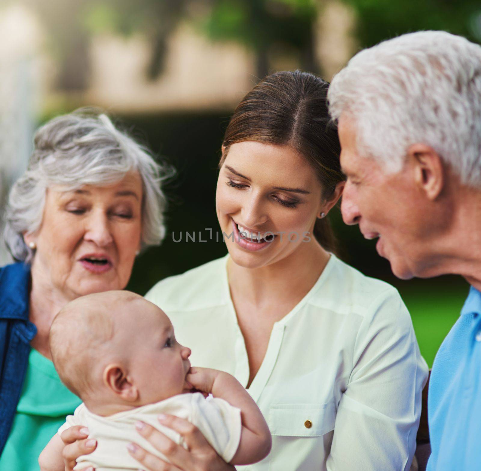 They just cant get enough of his cuteness. a three generational family spending time outdoors