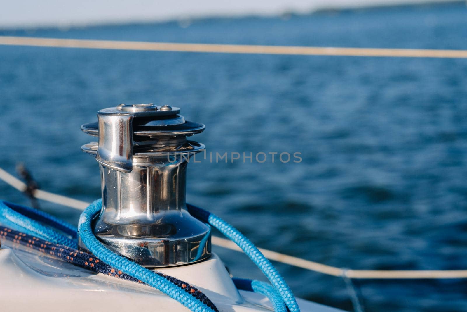 rope on the winch of a white yacht in the sea.yacht equipment.