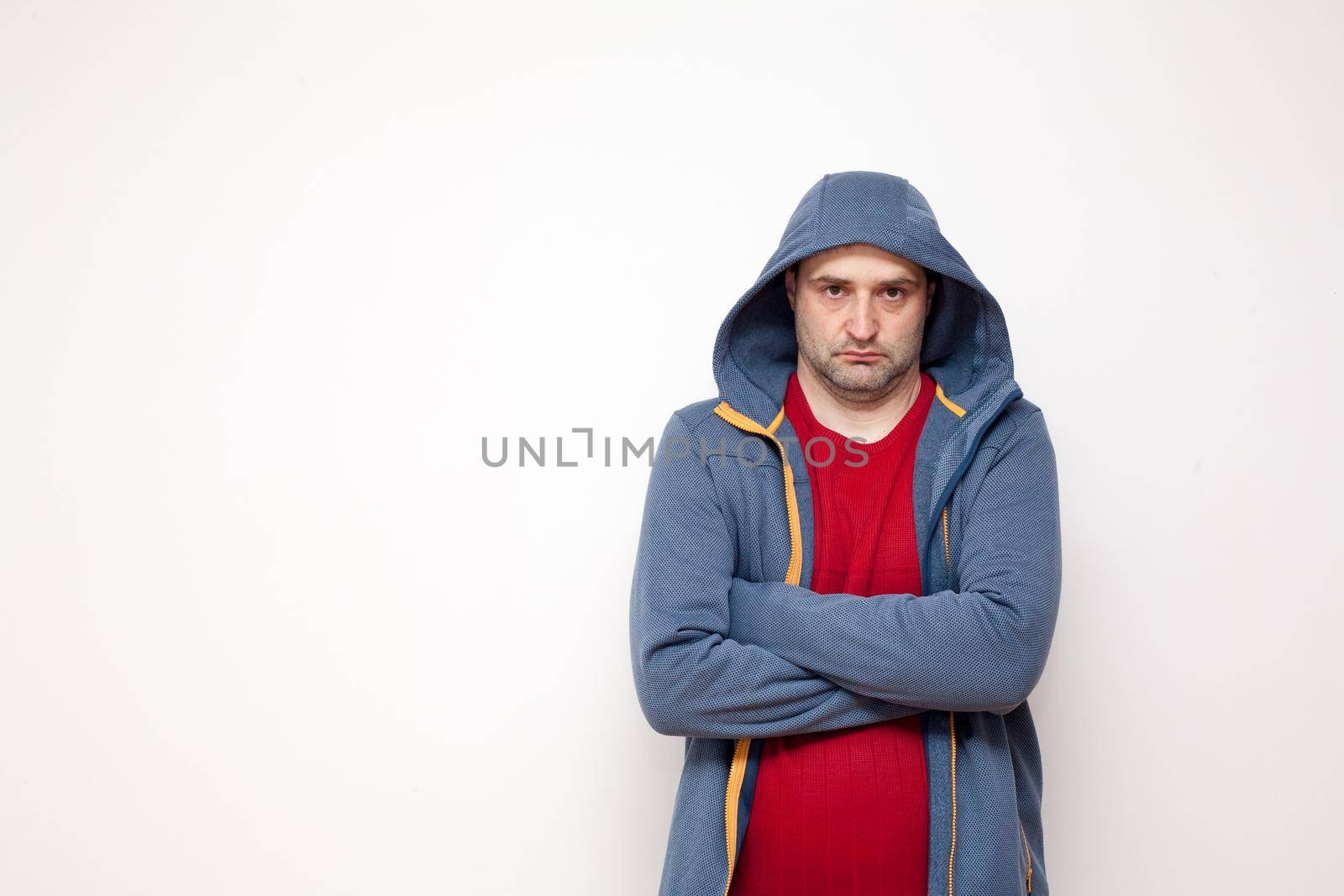 Man on white background. A man with a red sweater and a blue jacket, with a hood.