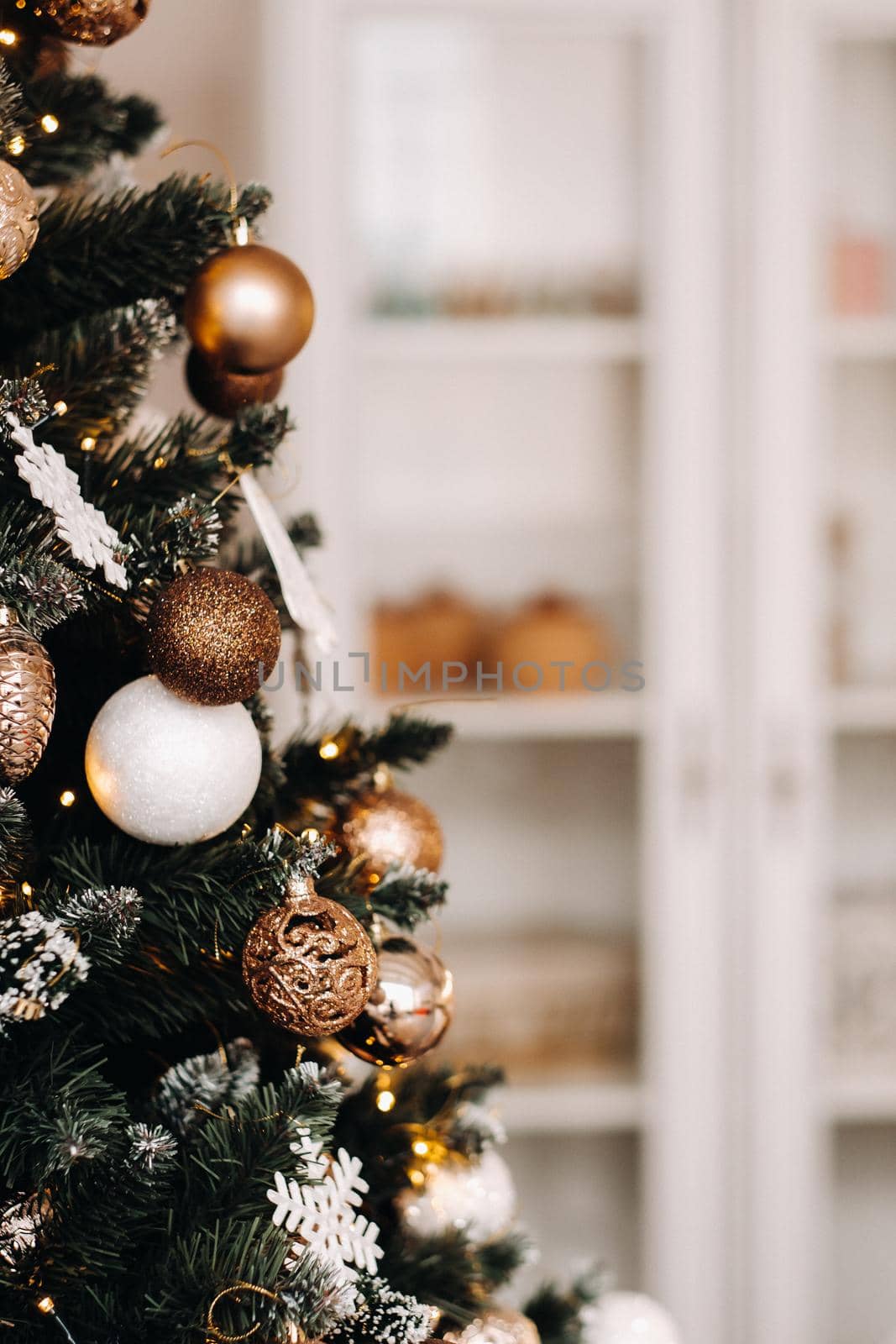 Christmas tree close-up. On New year's eve, a decorated snow-covered Christmas tree. by Lobachad