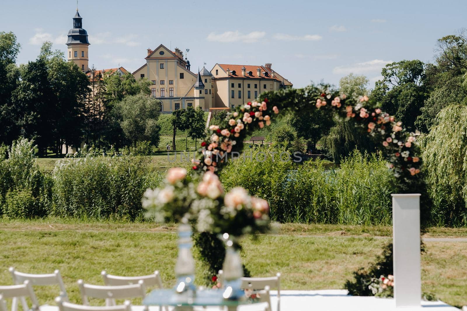 Wedding ceremony on the street on the green lawn near the Nesvizh Castle.Belarus.