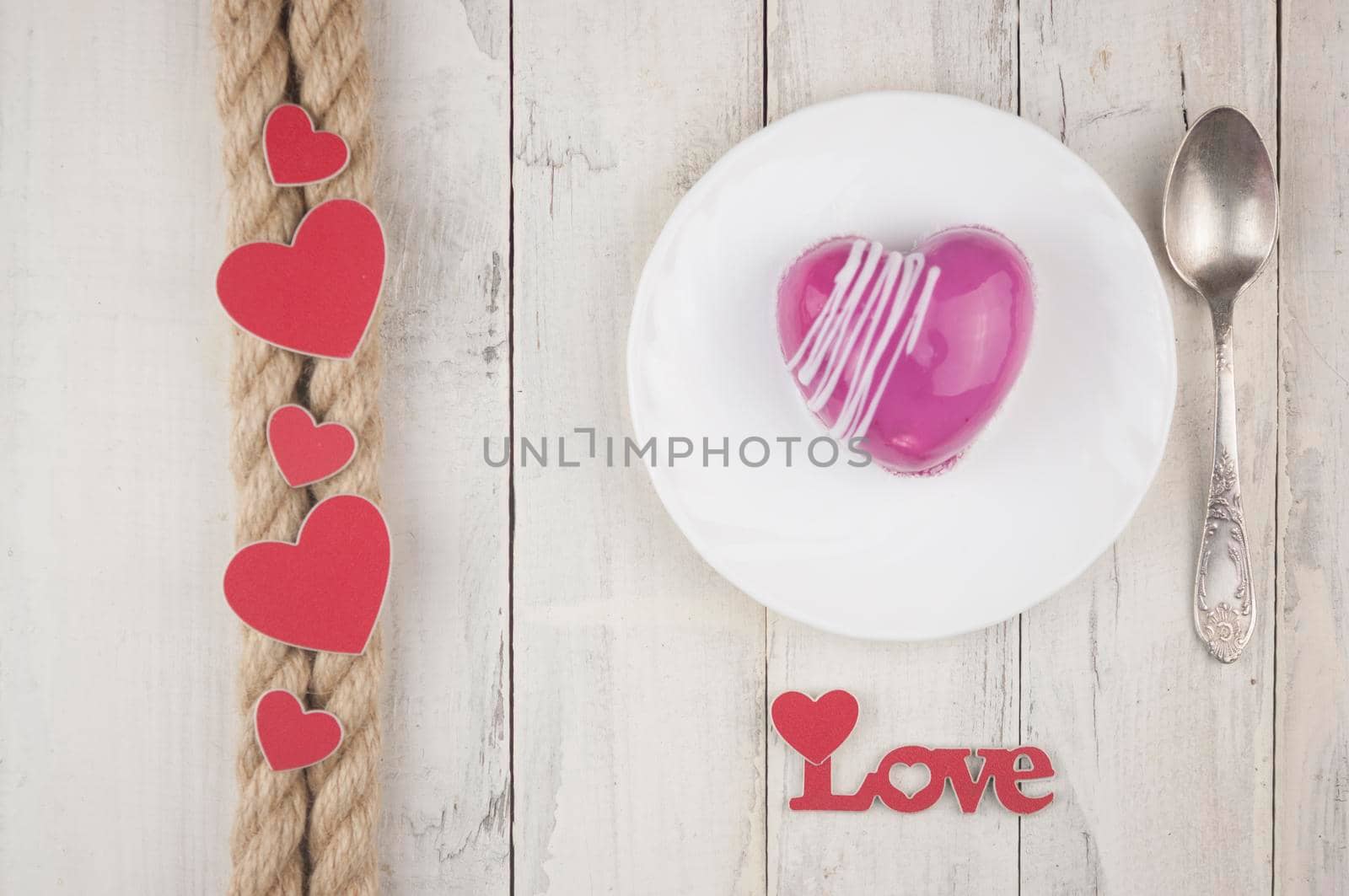 word love with red cake in the shape of a heart is on the white wood table. Romantic date. breakfast. Birthday. Wedding. Holiday. Top view