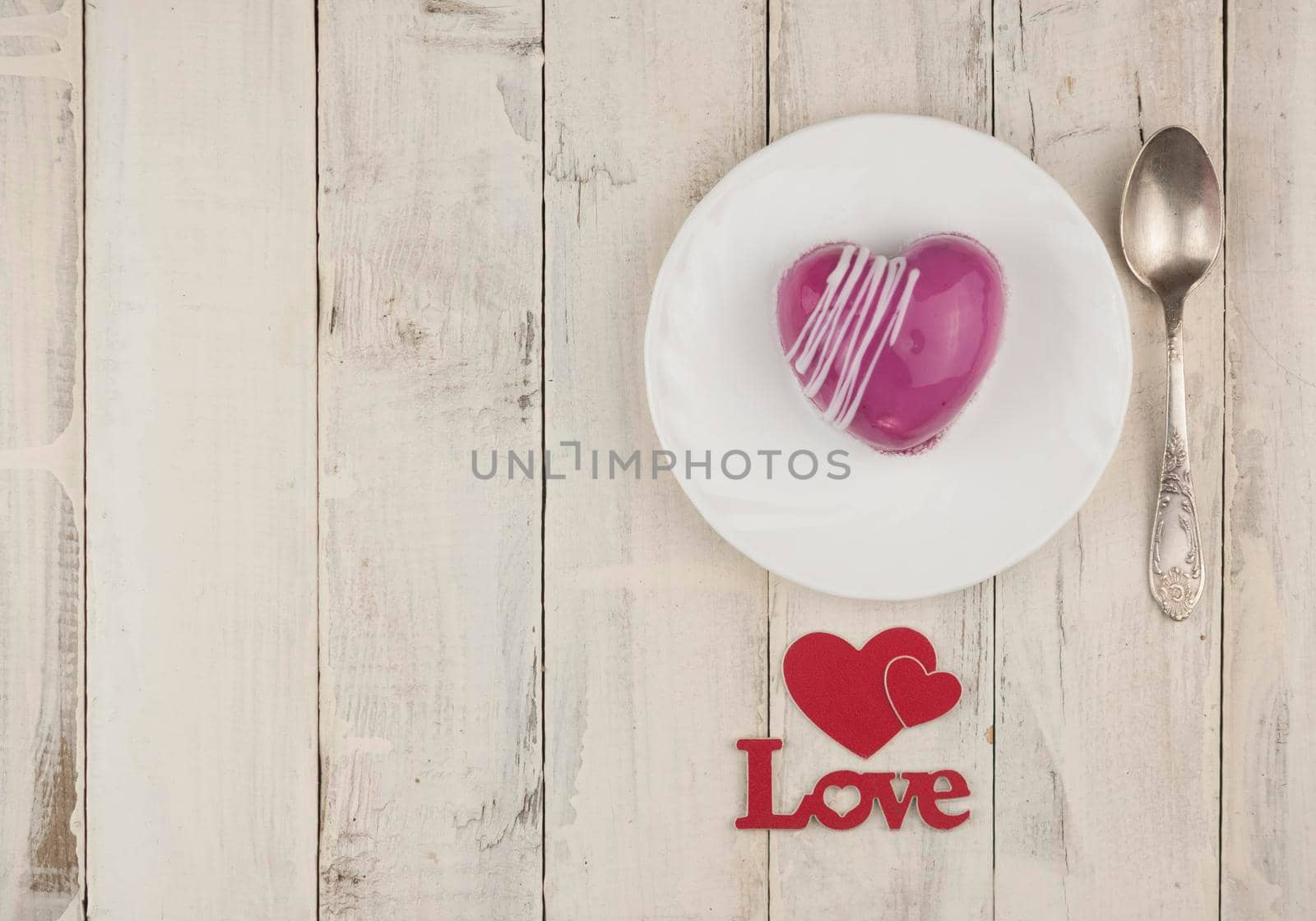 word love with red cake in the shape of a heart is on the white wood table. Romantic date. breakfast. Birthday. Wedding. Holiday. Top view