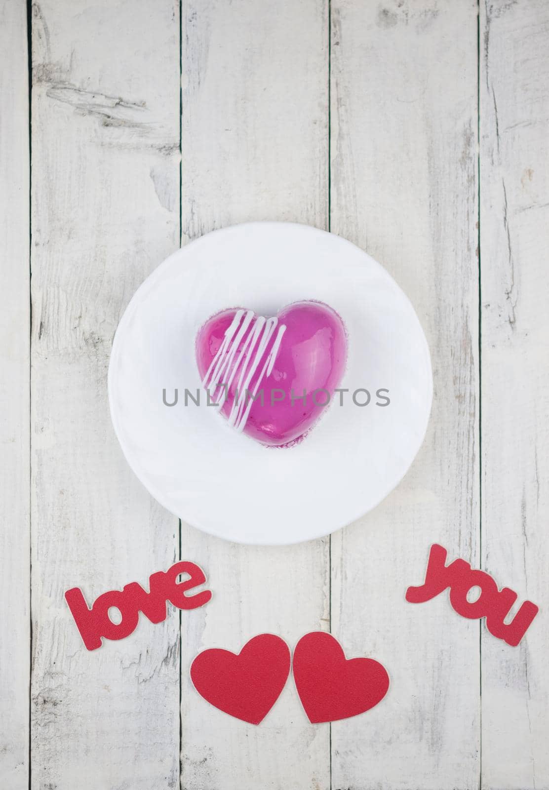 word love with red cake in the shape of a heart is on the white wood table. Romantic date. breakfast. Birthday. Wedding. Holiday. Top view