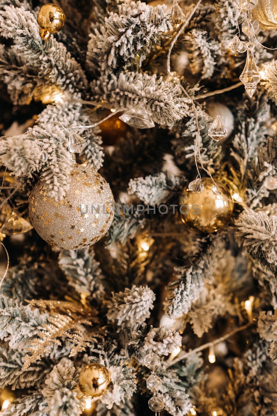 Christmas tree close-up. On New year's eve, a decorated snow-covered Christmas tree