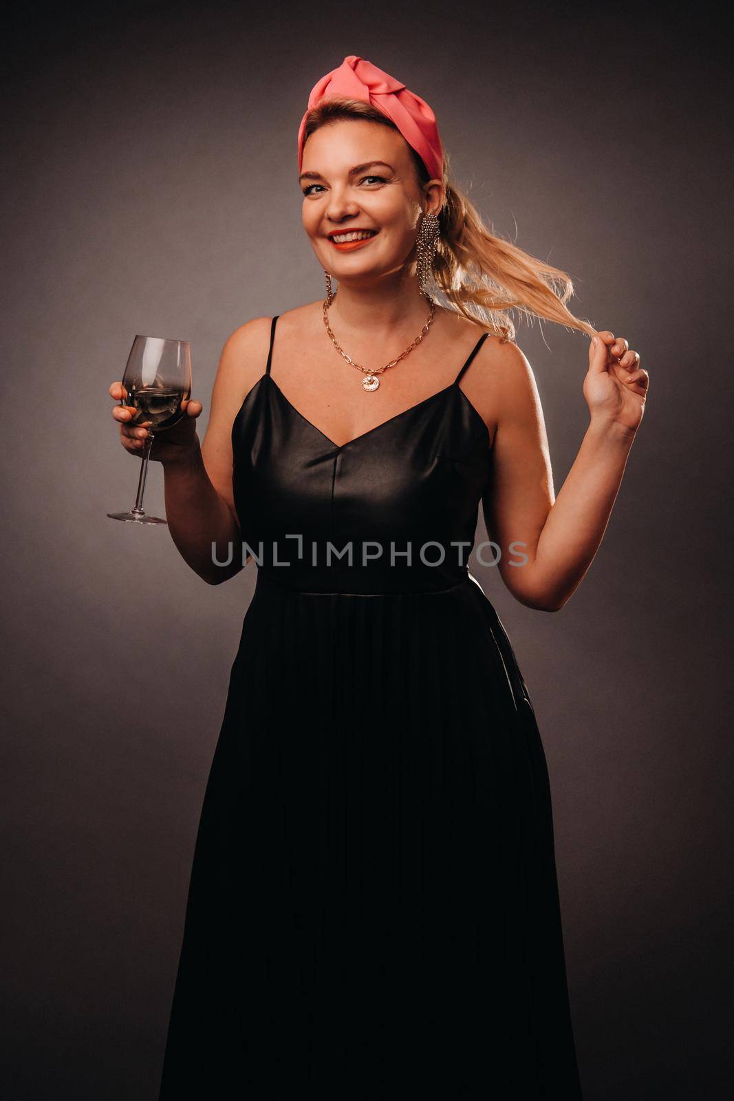 a woman in a black dress holding a glass of champagne on a black background, Christmas, holiday by Lobachad