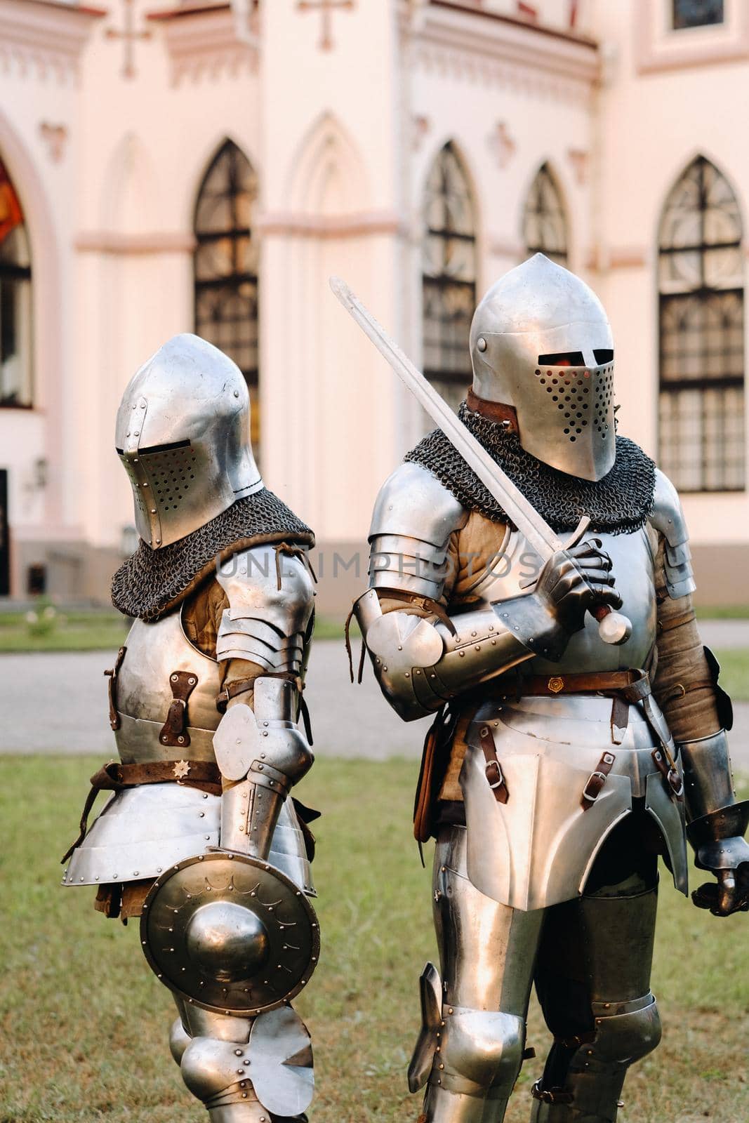 Two knights in armor on the background of the medieval Kossovsky castle.A medieval concept.Metallic texture by Lobachad