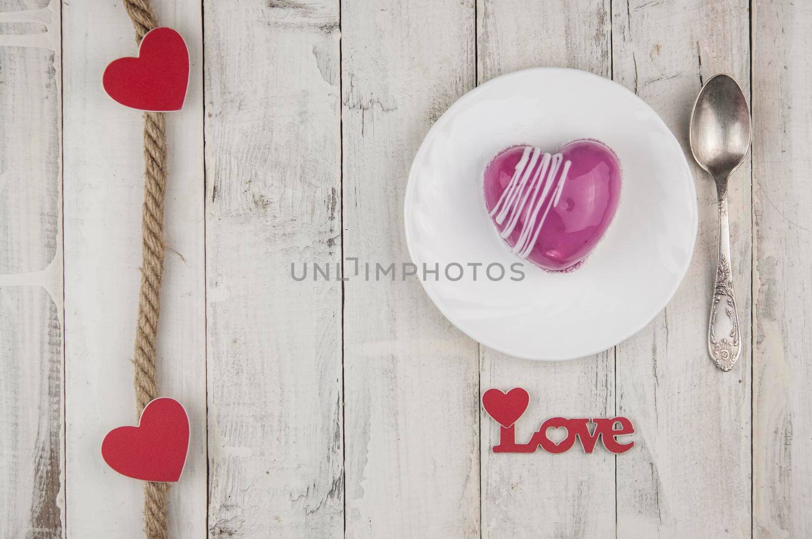 word love with red cake in the shape of a heart is on the white wood table. Romantic date. breakfast. Birthday. Wedding. Holiday. Top view