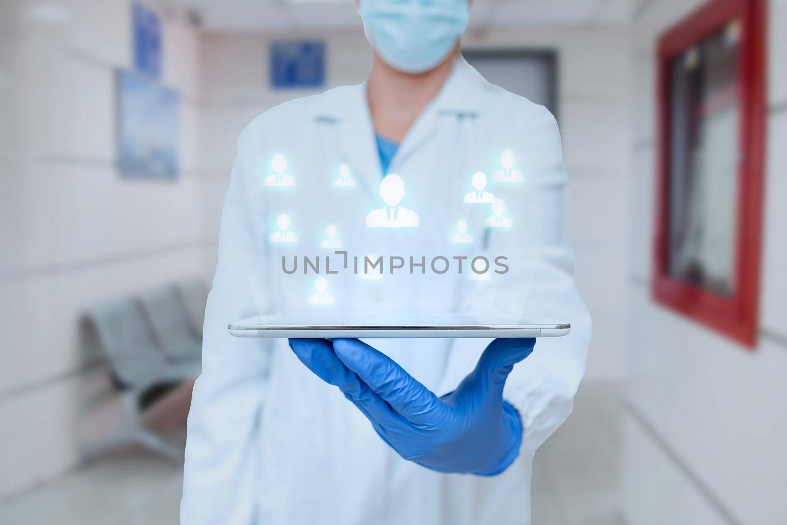 Doctor In Uniform Standing Holding Tablet And Virtually Typing With Pen. Nurse Carrying Pad Typing And Displaying New Medical Futuristic Technologies. by nialowwa