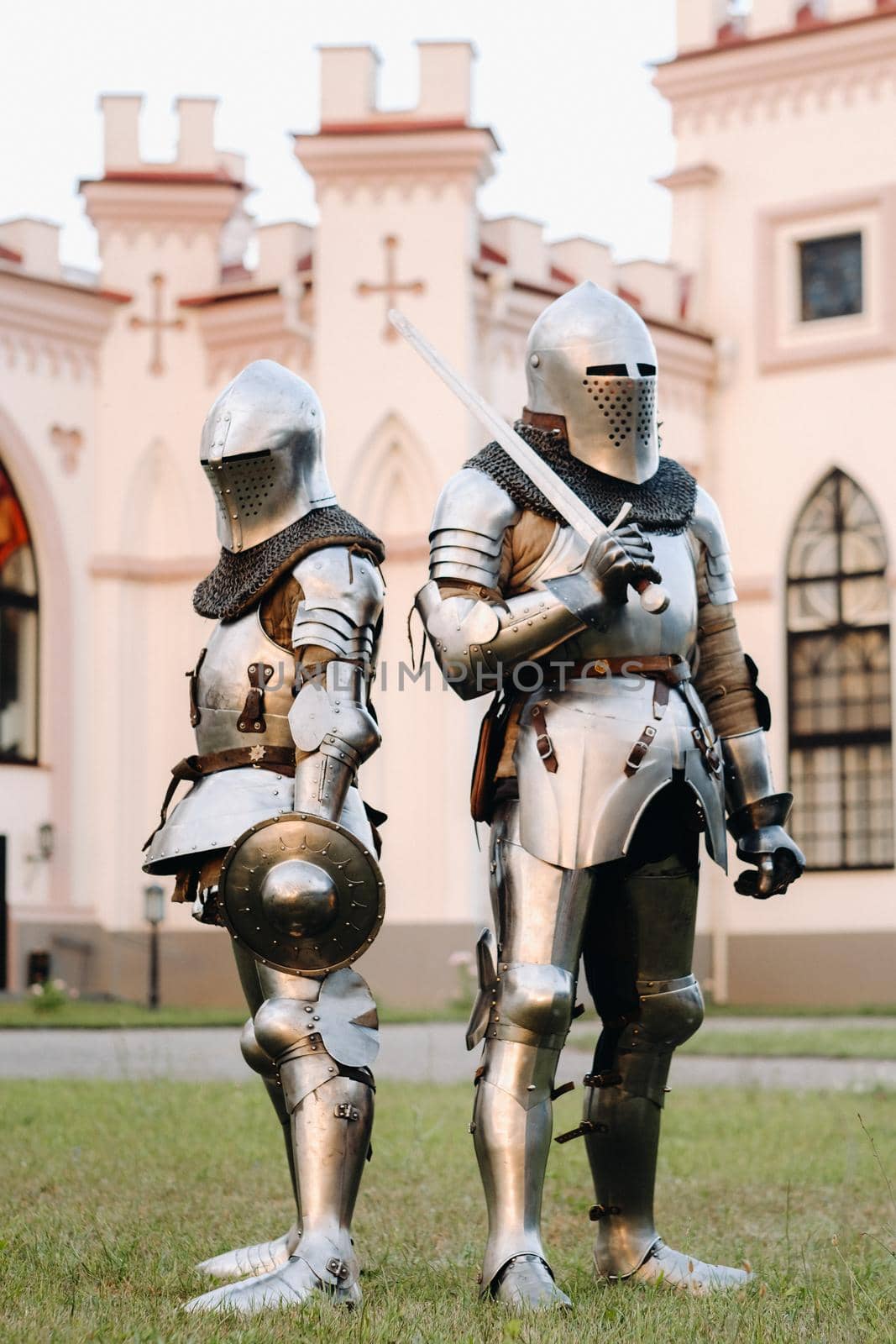 Two knights in armor on the background of the medieval Kossovsky castle.A medieval concept.Metallic texture by Lobachad