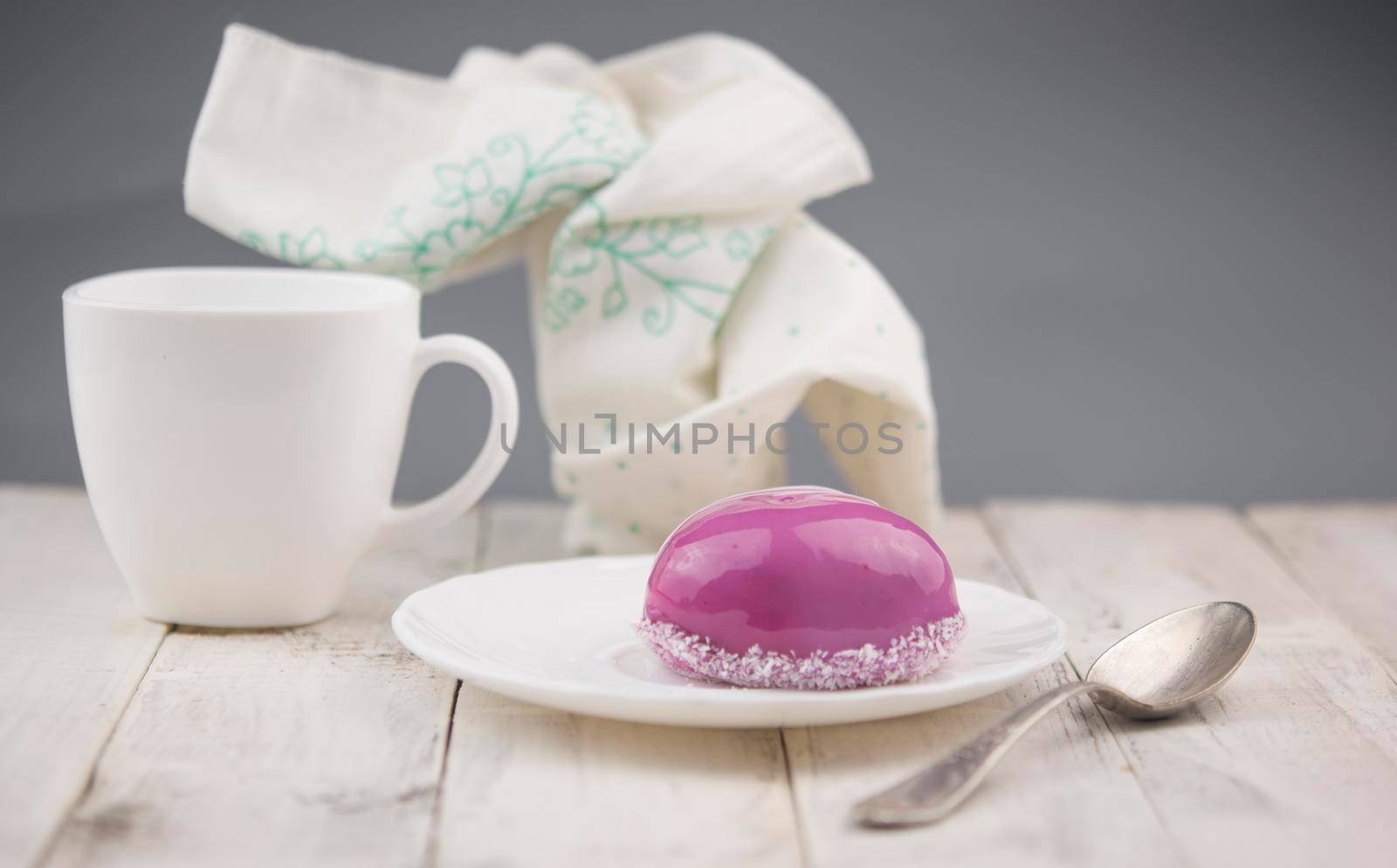 Red cake in the shape of a heart is on the table. Romantic date