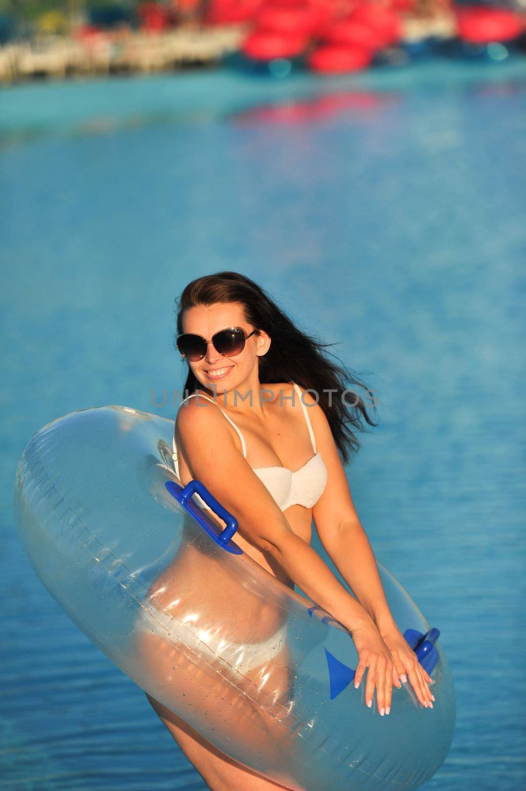 A woman in a white bathing suit with an inflatable circle in a water Park by Lobachad