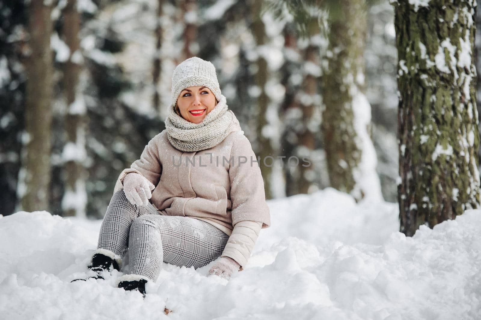 Portrait of a woman in gray clothes in a winter forest.Girl in the new year's snow-covered forest. by Lobachad