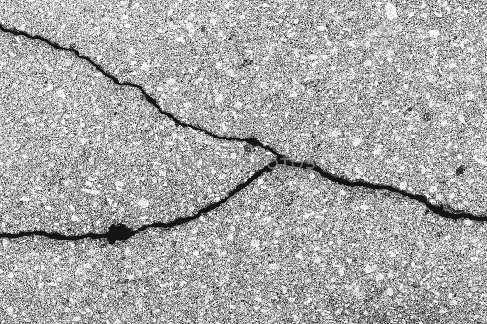 Cracked texture of gray asphalt. Abstract background for design.