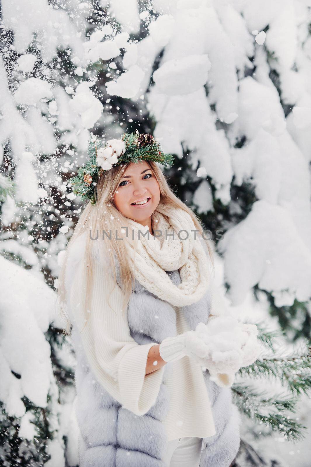 Portrait of a woman in a white fur coat in a cold winter forest. Girl with a wreath on her head in a snow-covered winter forest by Lobachad