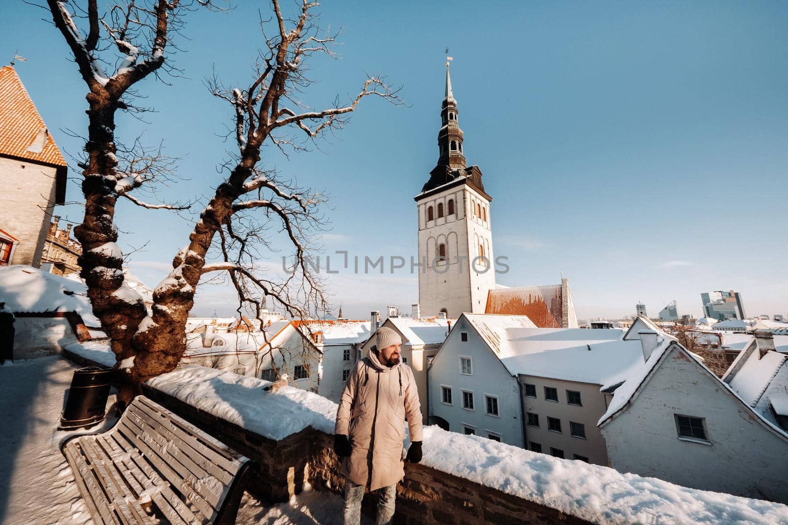 male tourist outdoors in winter in the old town of Tallinn.Estonia by Lobachad