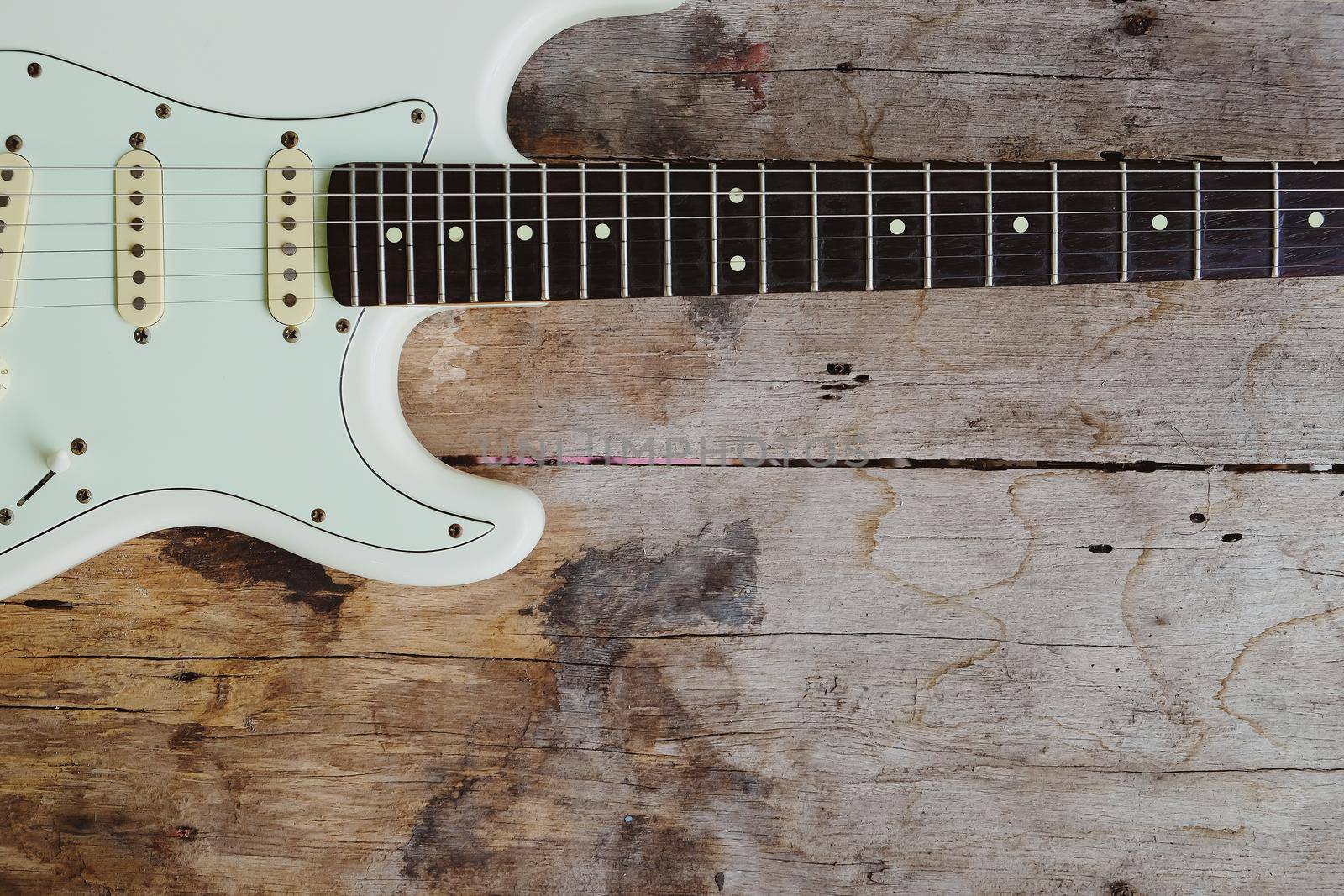 Detail of Acoustic Guitar on a wood background