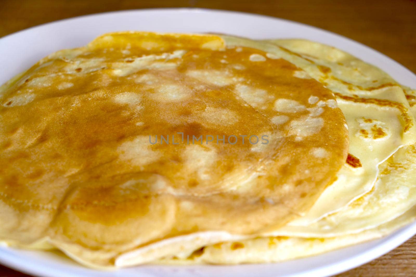 Plate with baked homemade pancakes. The onset of spring. Light breakfast