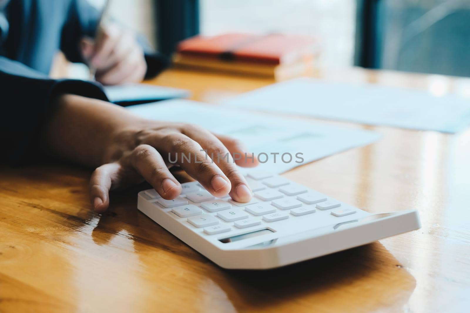 Close up Businessman and partner using calculator and laptop for calaulating finance, tax, accounting, statistics and analytic research concept.