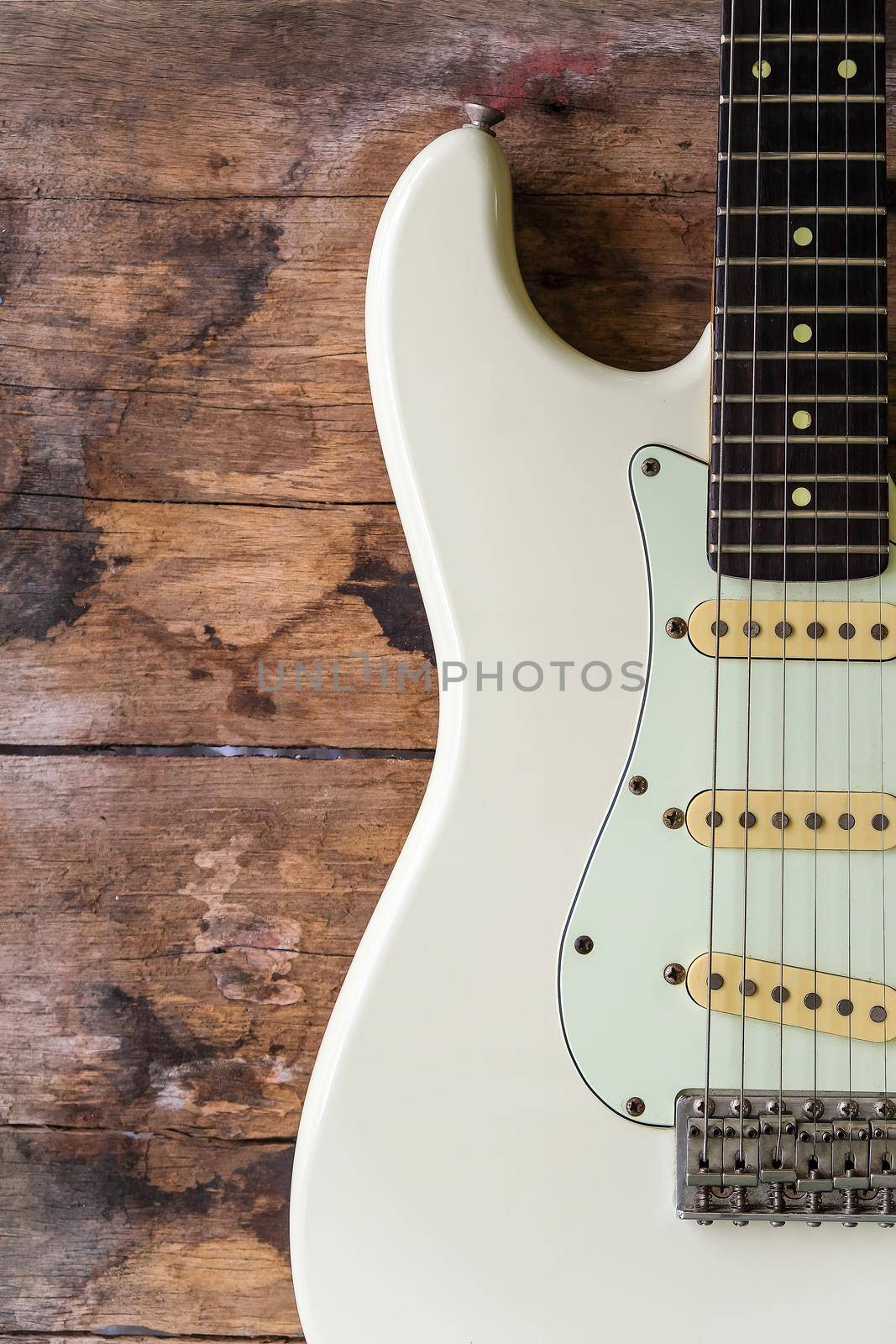 Detail of Acoustic Guitar on a wood background