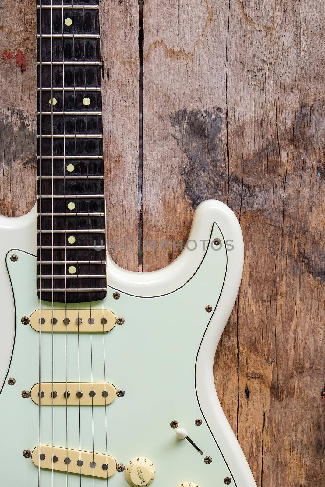 Detail of Acoustic Guitar on a wood background