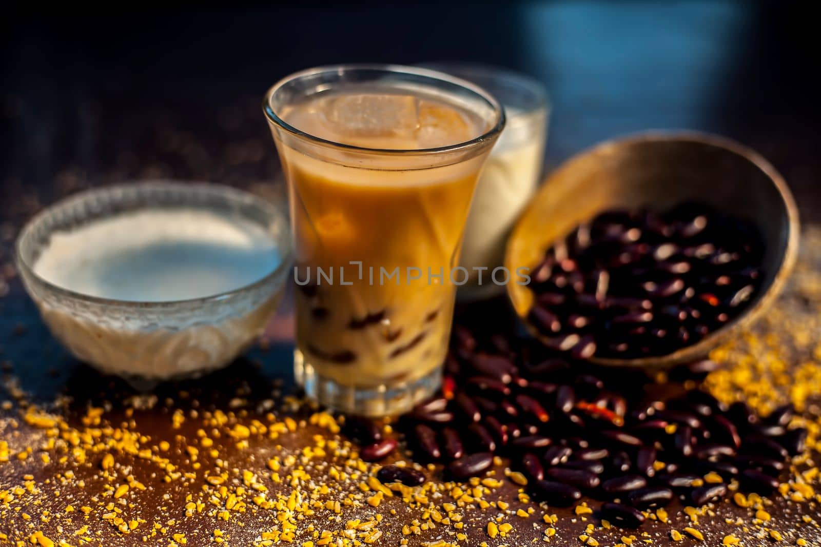 Red bean or kidney bean smoothie in a glass along with some red bean paste, banana, yogurt, milk, and oatmeal. Horizontal shot.