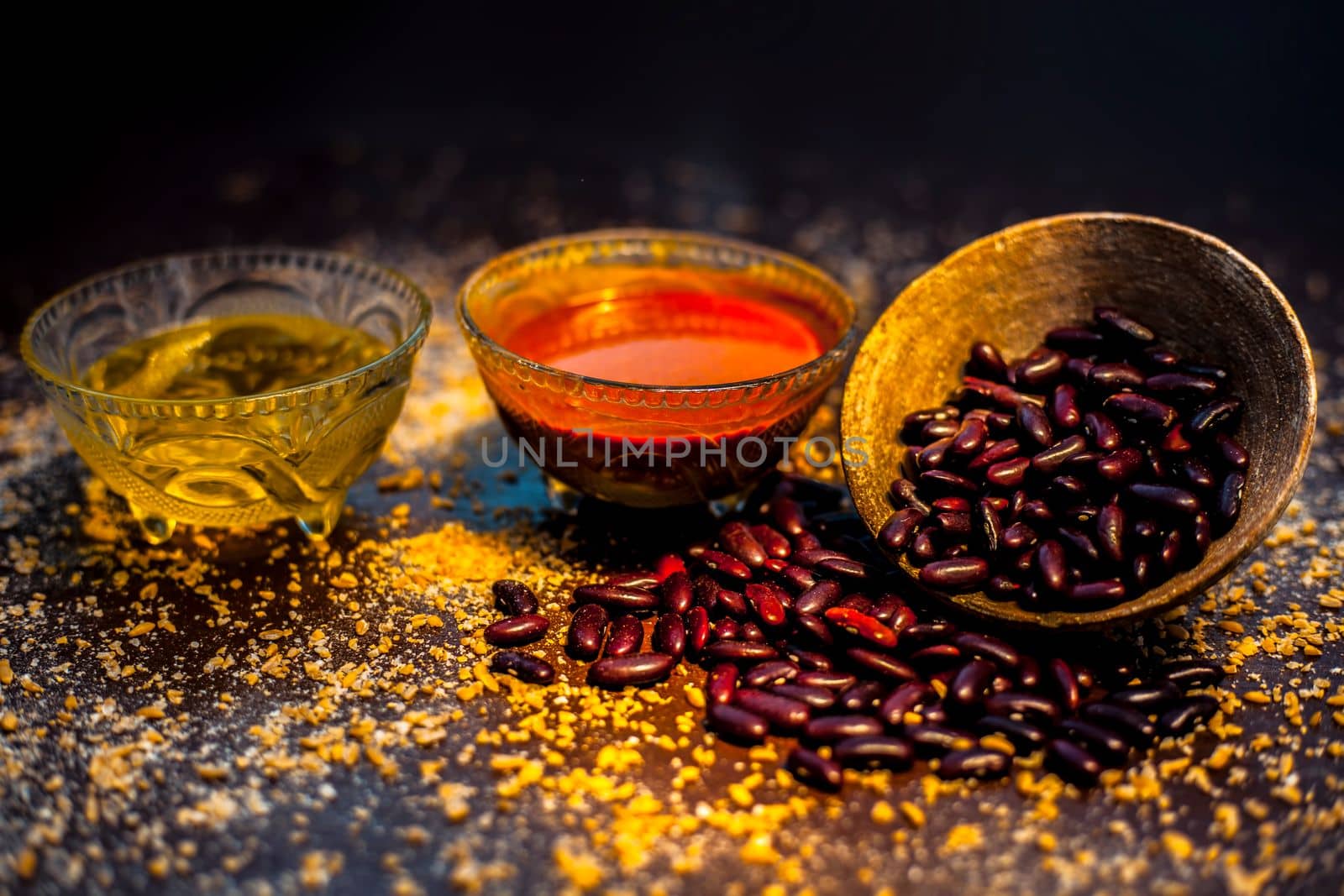 Home pore remedy on the black glossy surface consisting of some red beans or kidney beans mung beans and some green tea. Well mixed together in a bowl. Face mask for pore prevention.Horizontal shot.