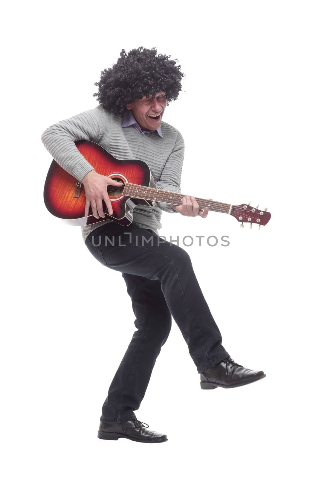 in full growth. cheerful man with a guitar. isolated on a white background.