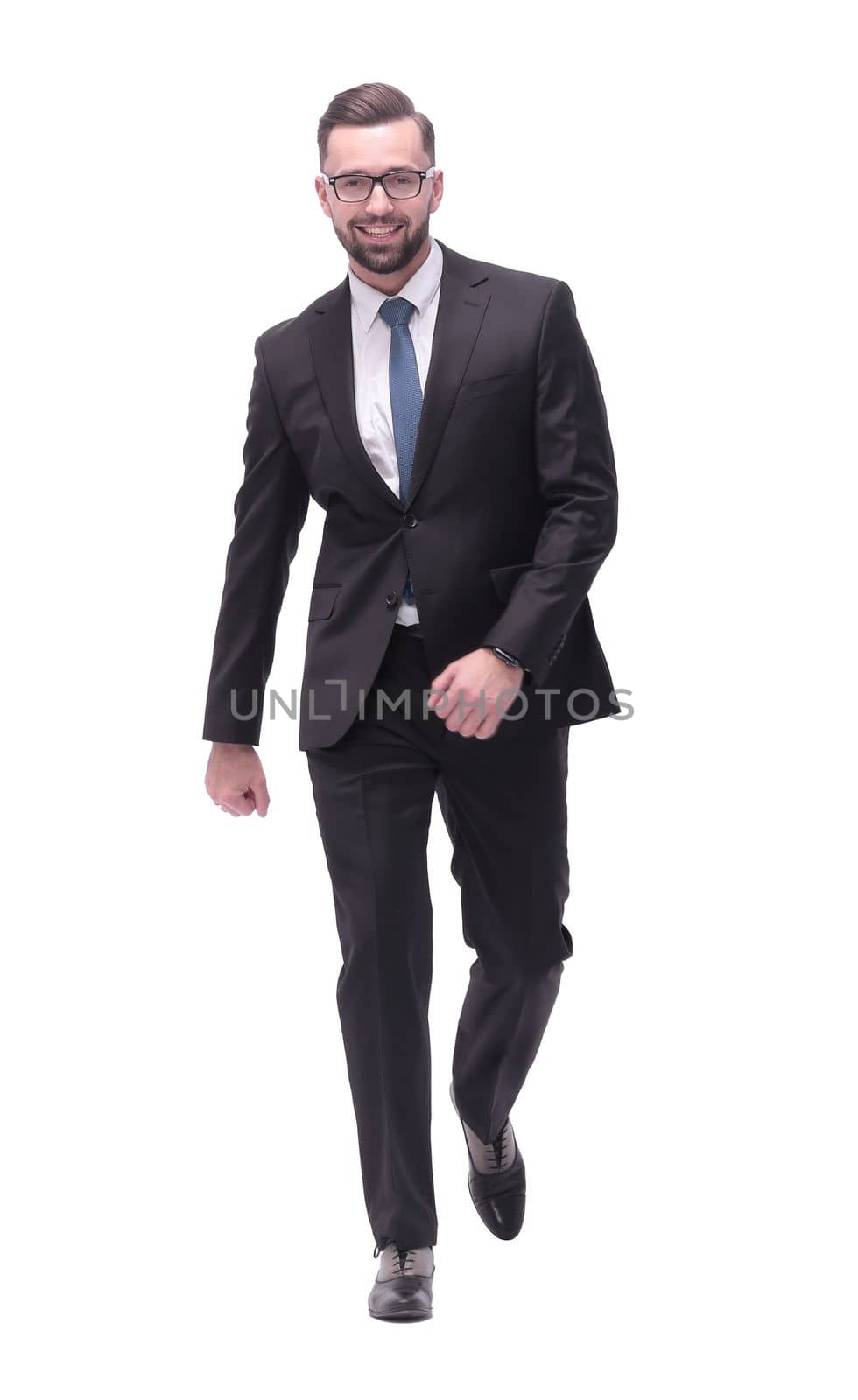 full length . confident young businessman moving forward. isolated on white background