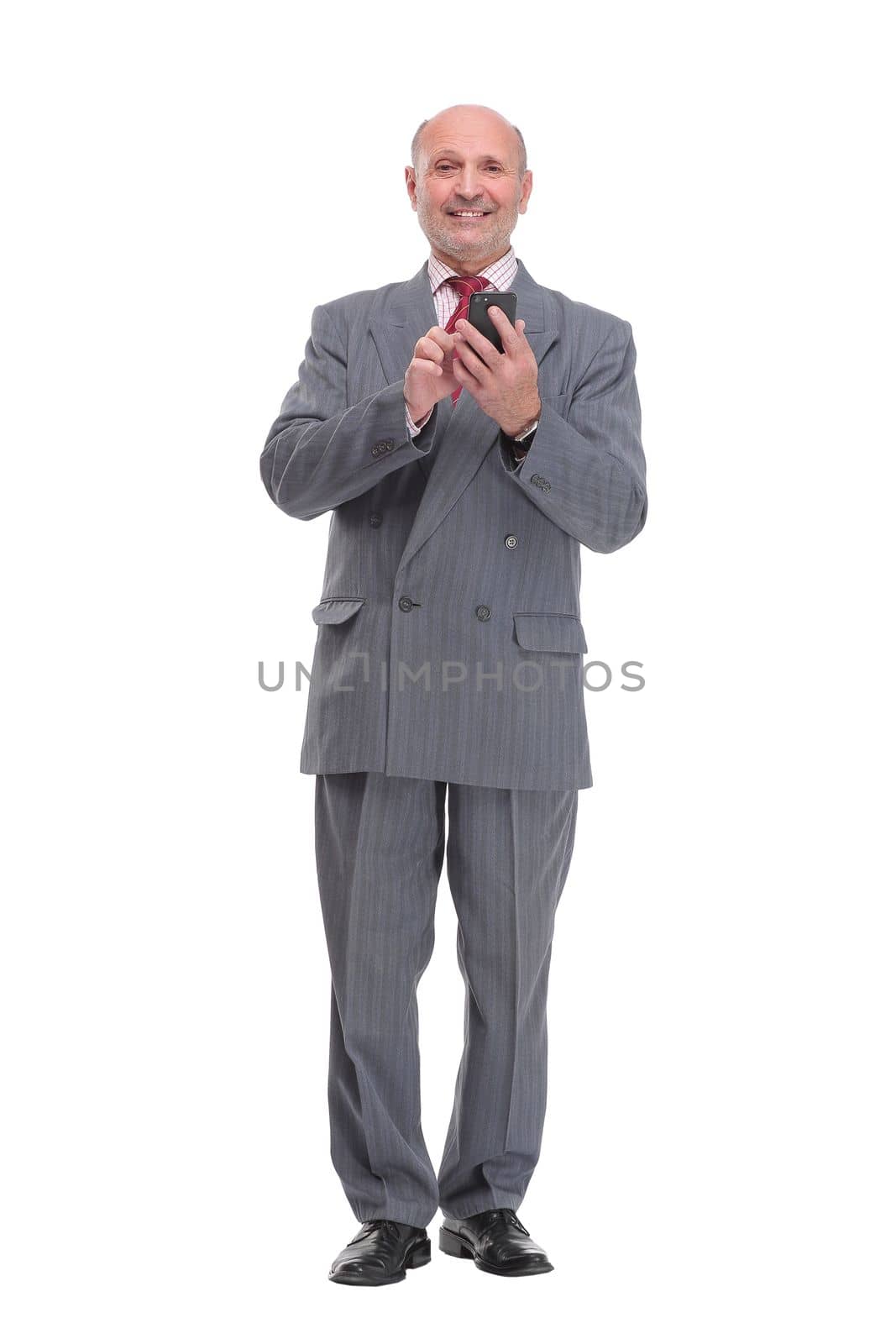 Casual senior man working something on his phone. isolated on white background