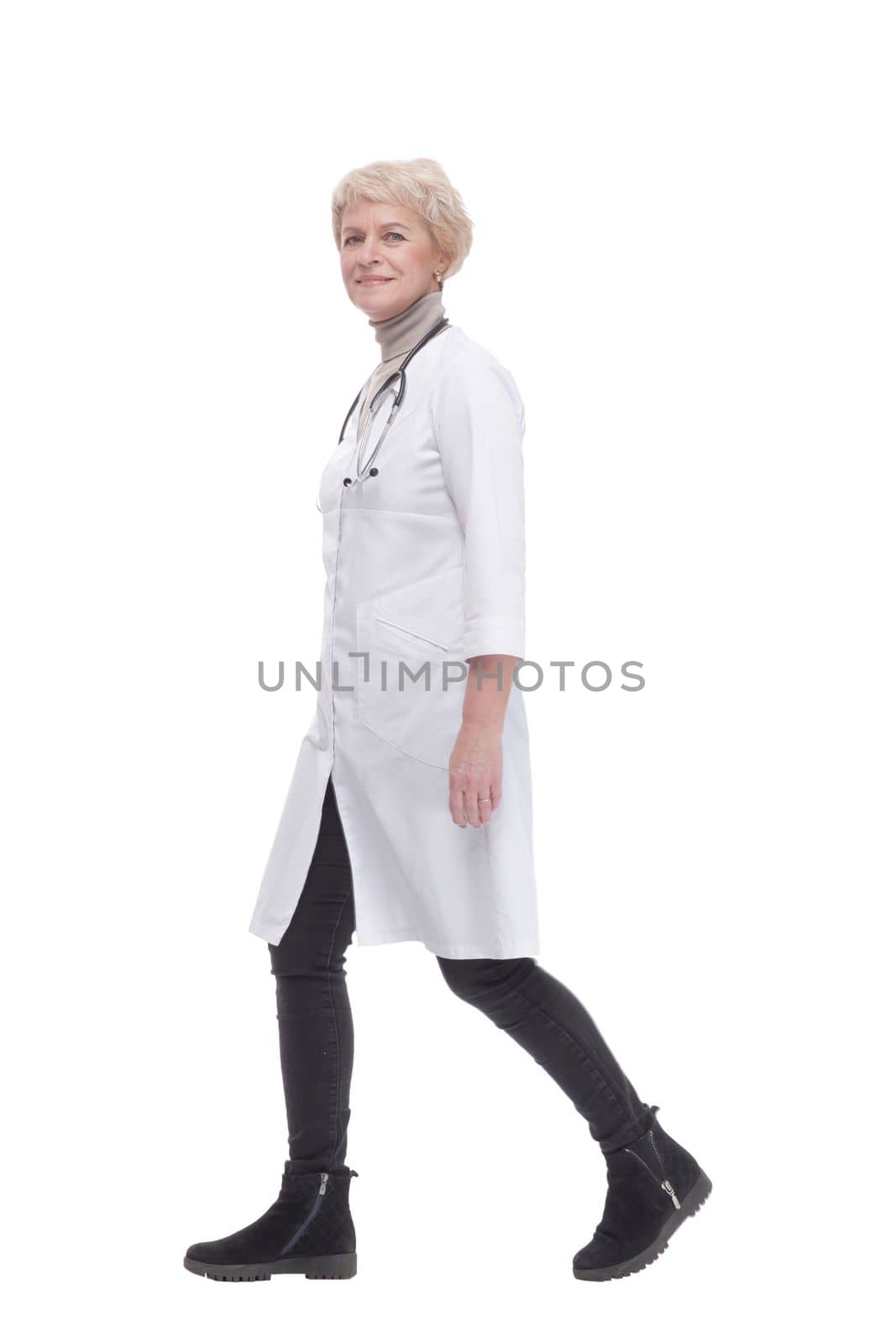 responsible female doctor with a stethoscope striding forward. isolated on a white background.