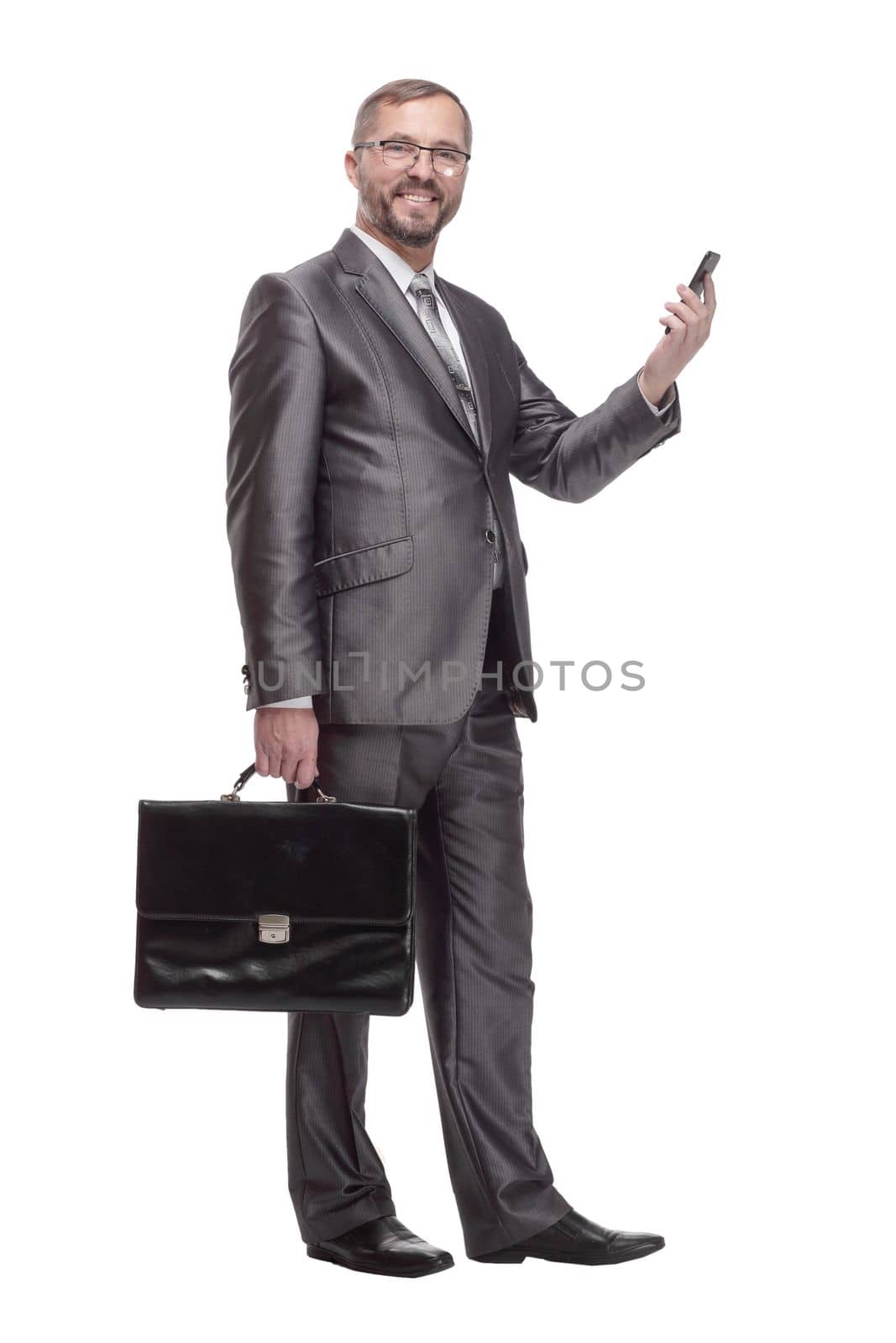 in full growth.Executive business man with a smartphone. isolated on a white background.glasses