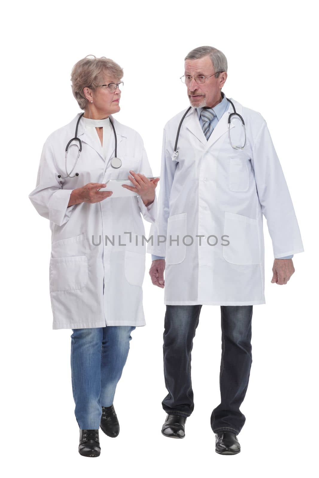 Group of doctors and nurses looking at X-ray on a white background