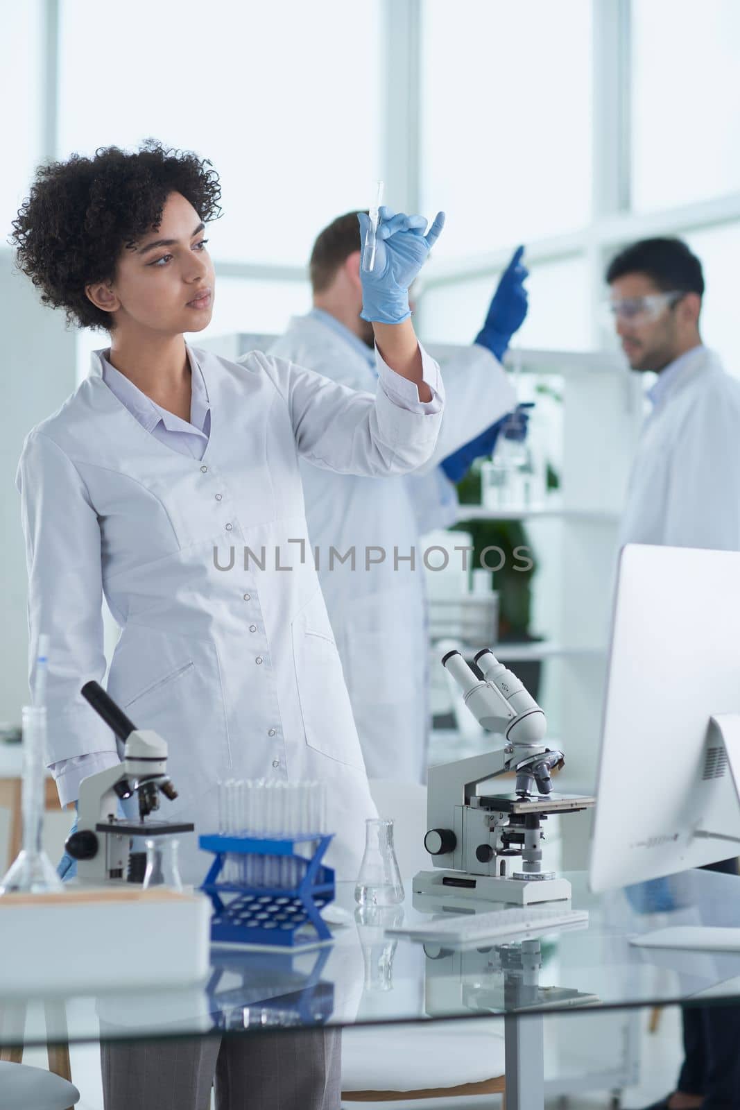 Team of Scientists Working Using Microscope, Analysing Microbiology Samples