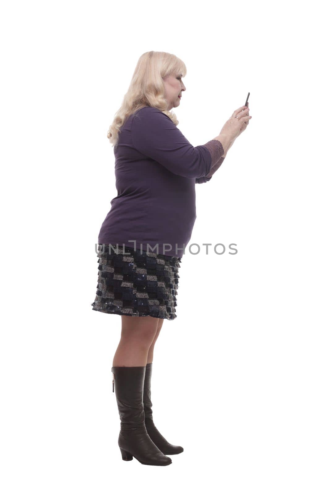 full-length. casual mature woman with a smartphone . isolated on a white background.