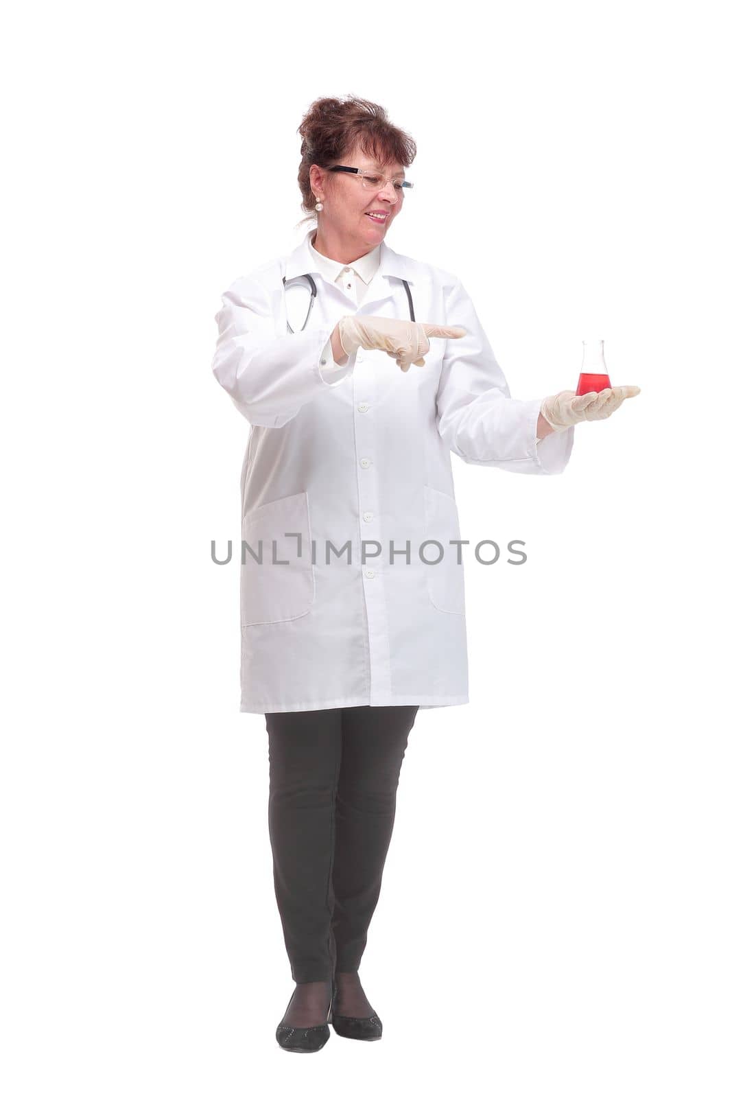Front view of mature woman doctor or scientist holding the red fluid in beaker and pointing finger to it