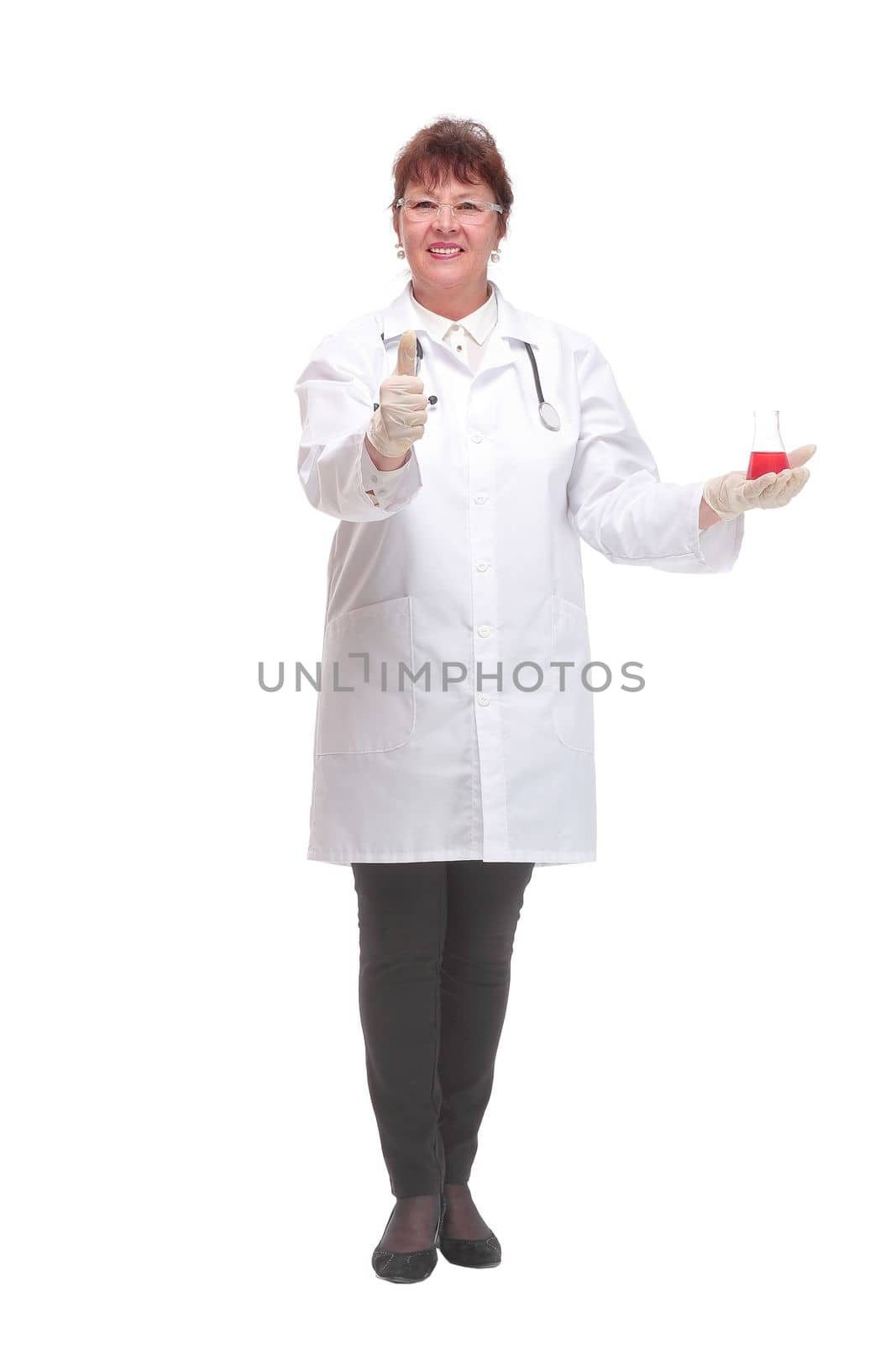 Front view of female scientist with beaker of red liquid on palm looking at camera