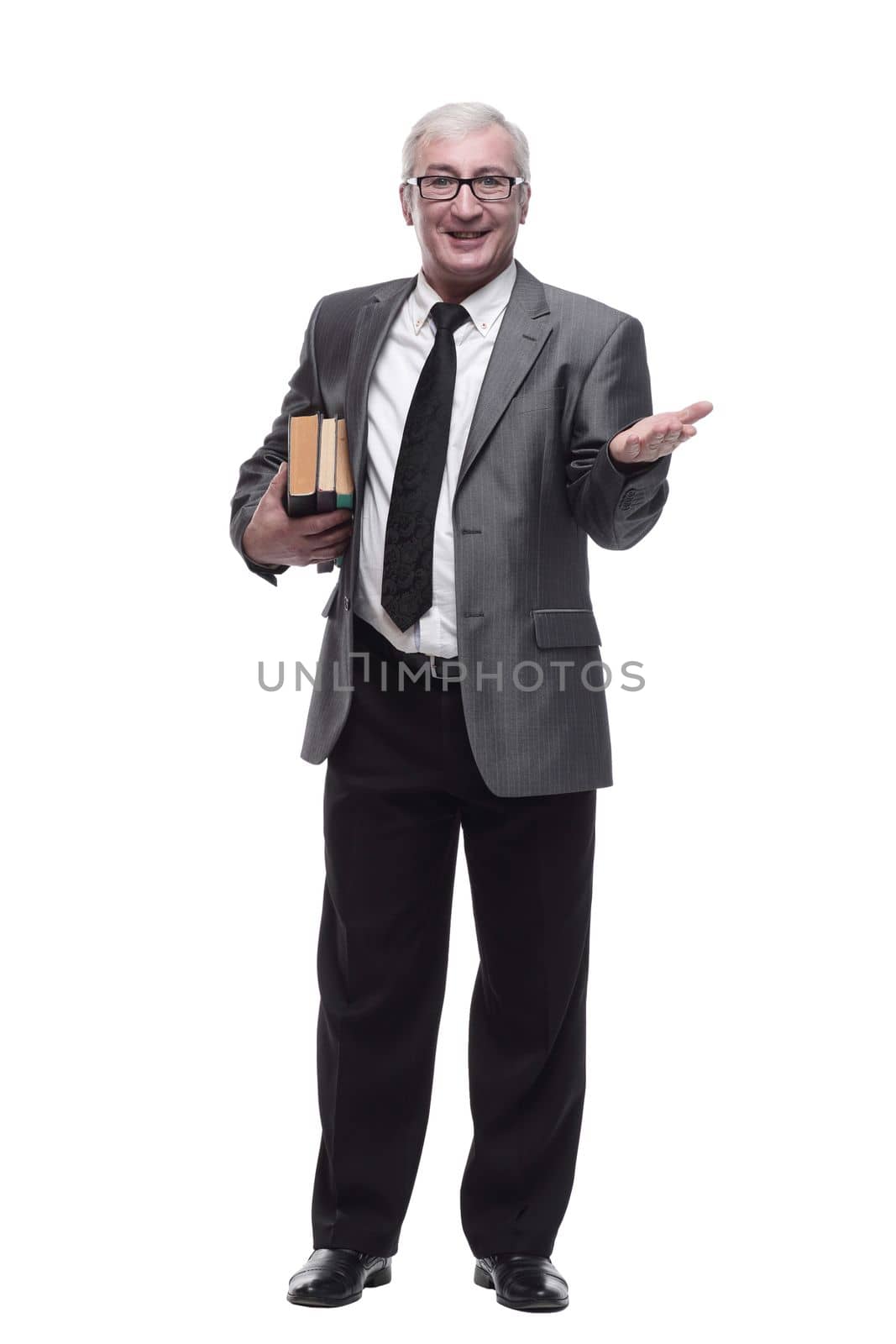 in full growth. smiling business man with a stack of books. isolated on a white background.