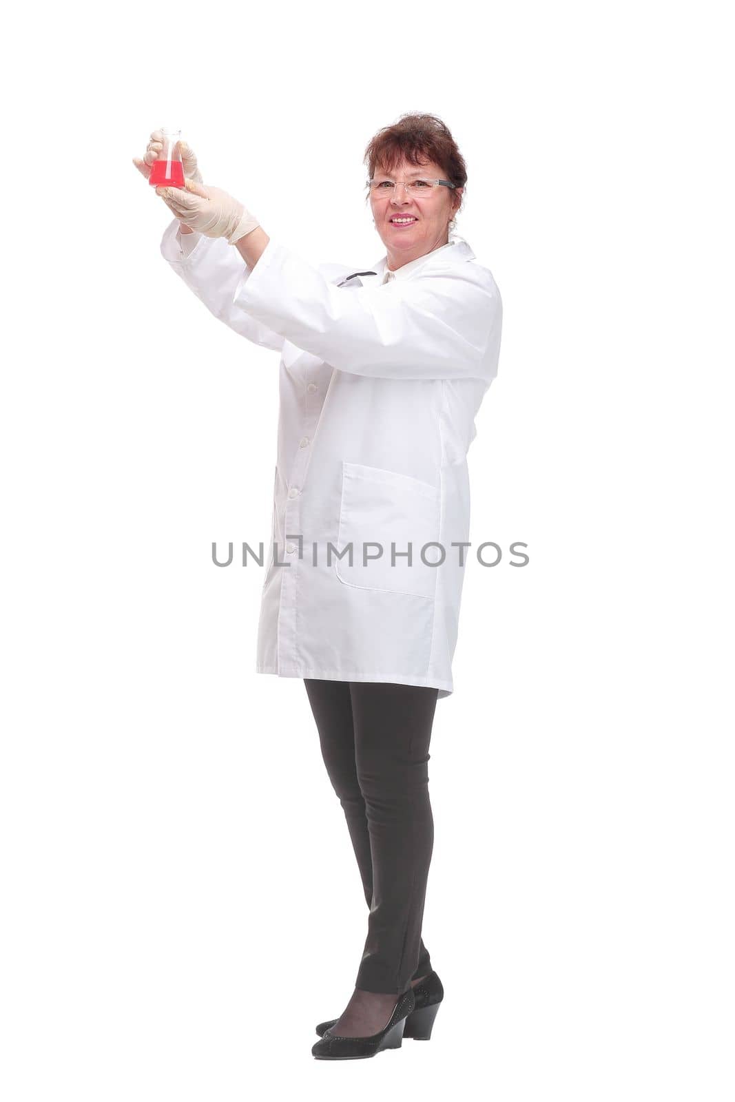 Side view of woman doctor dark hair in medical coat or scientist holding beaker with red liquid isolated over white