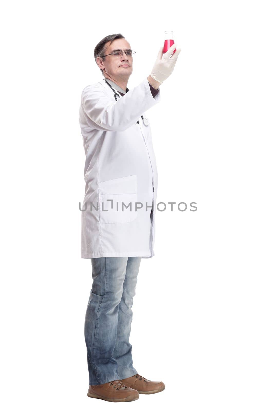 serious doctor with a laboratory flask in his hands . isolated on a white background.